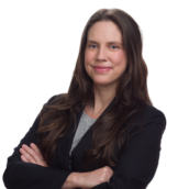 Professional headshot of Sara Lerner, woman in dark business blazer, arms crossed